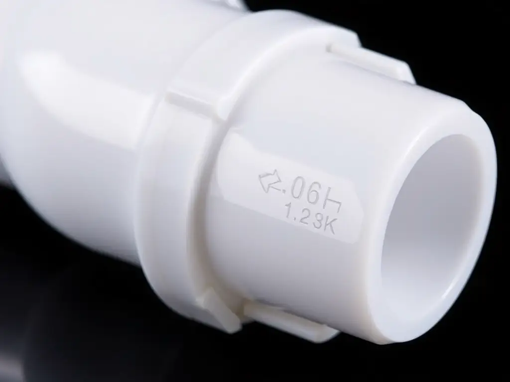 A close-up shot of a polyethylene fitting, showcasing its smooth surface and precise dimensions, with a focus on the fitting's size markings.